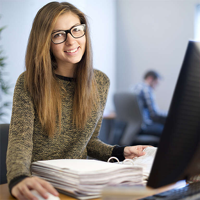 Junge Frau am Büro-Arbeitsplatz